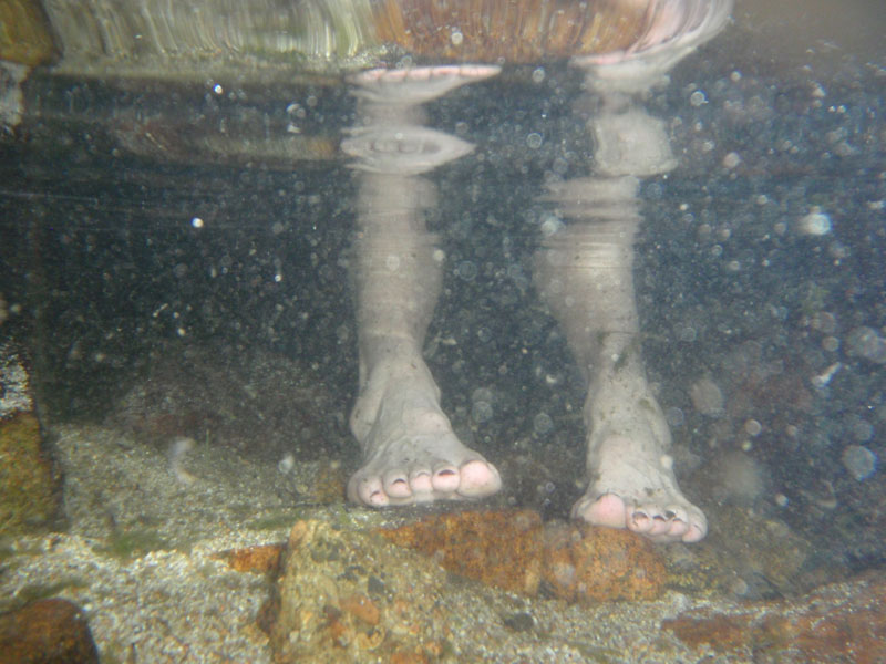 April soaks her feet in the river